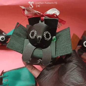 Free leather cat pattern for beginners close up with red bow and green box