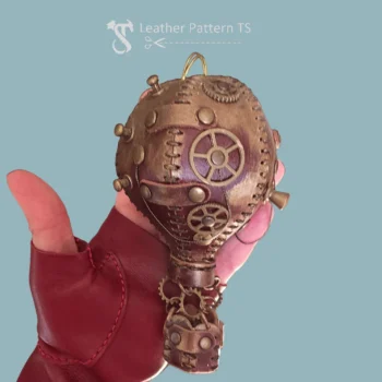 Steampunk leather balloon pattern in hand with gears and stitched panels