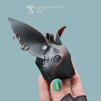 DIY leather rabbit charm side view in hand with black stitched details