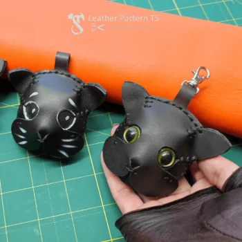 Leather cat keychain template front view showing two black cat charms on table