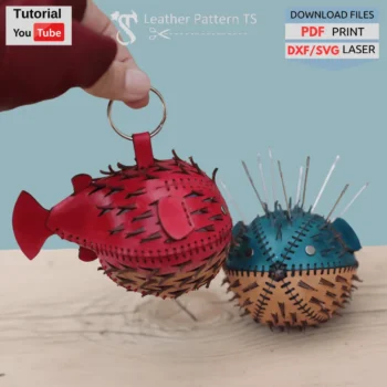 Leather fugu pattern – two example pincushions and backpack pendants made from template, front view in hand