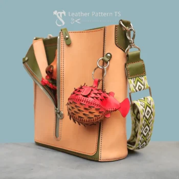 DIY leather backpack pendant – red fugu coin purse pattern attached to bag Leather pincushion template – blue and red fugu examples from animal shape leather pattern, held in hand
