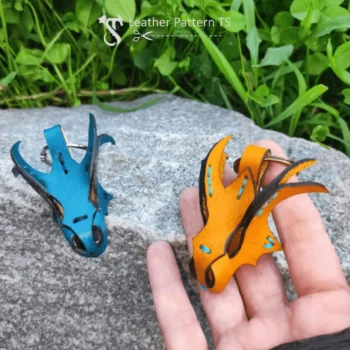 Leather dragon keychain template two colorful charms blue and orange on rock