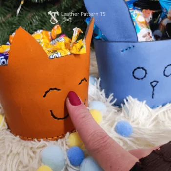 Cat candy basket pattern handheld front view filled with wrapped sweets